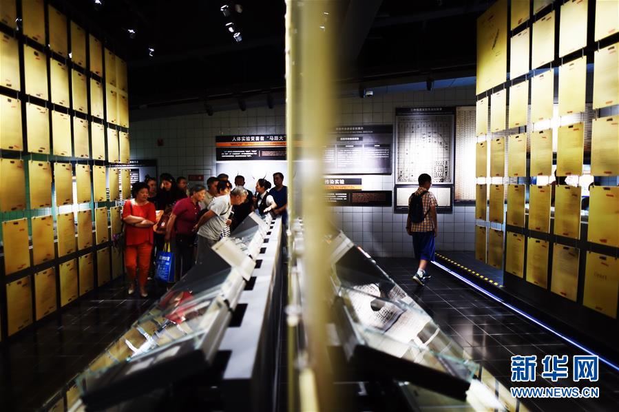 在侵华日军第七三一部队罪证陈列馆,参观者在了解人体实验报告书(8月16日摄)。新华社记者 王建威 摄 在侵华日军第七三一部队罪证陈列馆,参观者在了解人体实验报告书(8月16日摄)。新华社记者 王建威 摄