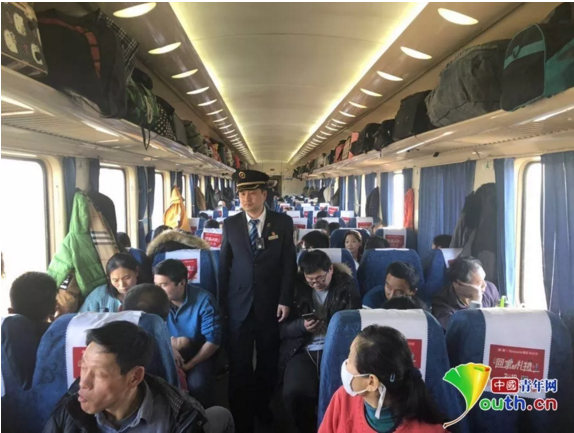 列车长费昊正在硬座车厢进行巡视