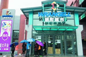 部分员工冒雨聚集在超市门口